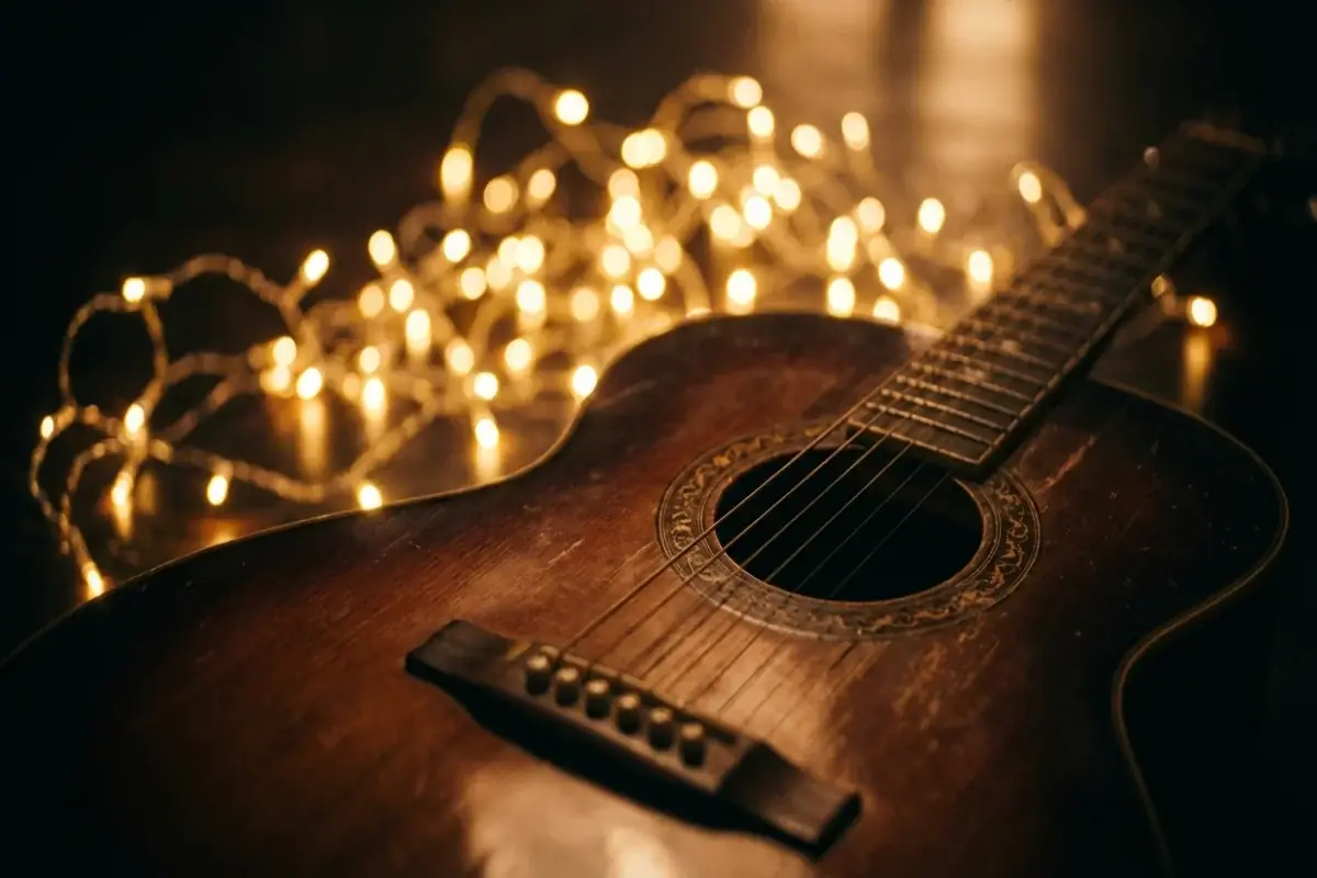 Acoustic guitar body with fairy lights reflecting as warm golden bokeh in celebration atmosphere